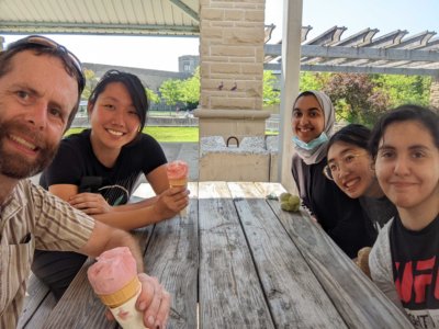 The Sinclair lab at a picnic table eating ice cream