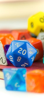 image of polyhedral dice with a d20 in focus